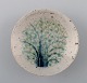 Snorre Stephensen for Royal Copenhagen: Small stoneware bowl decorated with tree 
in blue and green glaze, overlaid with transparent glaze.