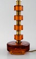 Erik Höglund style brass table lamp with mouth-blown orange art glass.
