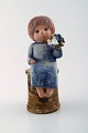 Lisa Larson for Gustavsberg. Rare stoneware figure. Girl with flowers.
