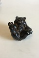 Royal Copenhagen Stoneware Figurine Brown bear cub on the back with paw against 
paw No 22747