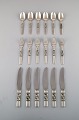 Georg Jensen. Cutlery, Scroll No. 22, Complete dinner service of hammered 
sterling silver.