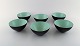 Set of six Krenit bowls by Herbert Krenchel. Black metal and mint green enamel. 
1970