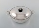 Just Andersen lidded bowl with handles in sterling silver. Edge adorned with 
chisels and lid knob in ebony. Model number 2309. Ca. 1950