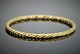 Antik 
Damgaard-
Lauritsen 
præsenterer: 
Georg 
Jensen; Snoet 
armring af 18 
kt. guld #1017A