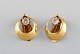 Scandinavian jeweler. A pair of 14 carat gold ear clip earrings with 
semi-precious stones. Mid 20th century.
