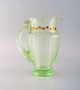 Emile Gallé (1846-1904). Early and rare jug in mouth-blown light green art glass 
with hand-painted gold decorations in the form of leaves. Museum quality, 1870s 
/ 80