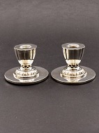 A pair of silvered candlesticks with pierced stem