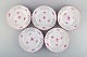 Fem antikke gennembrudte Meissen tallerkener i håndmalet porcelæn med lyserøde 
blomstermotiver. 1800-tallet.
