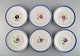 Six antique Royal Copenhagen plates in hand-painted porcelain with flowers and 
blue border with gold. Model number 592/9051. Late 19th century.
