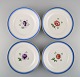 Four antique Royal Copenhagen plates in hand-painted porcelain with flowers and 
blue border with gold. Model number 592/9051. Late 19th century.
