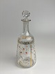 Beautiful, small, antique carafe in clear glass. Decorated with enamel paint in 
white, yellow and gold with motif of daisies