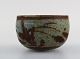 Åland, contemporary ceramicist. Bowl in glazed stoneware. Beautiful glaze in 
brown and blue-green shades. Late 20th century.
