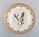 Royal Copenhagen flora danica deep plate in porcelain with hand-painted flowers 
and gold decoration. Early 20th century.
