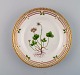 Royal Copenhagen Flora Danica salad plate in hand-painted porcelain with flowers 
and gold decoration. Model number 20/3573.
