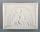 Bing and Grondahl after Thorvaldsen. Antique biscuit wall plaque. Cupid and a 
dog. Late 19th century.
