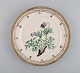 Royal Copenhagen Flora Danica plate in hand-painted porcelain with flowers and 
gold decoration. Dated 1948.
