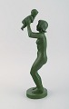 Niels Tvede (1903-1972) for Ipsens Enke. Figure in jade green glazed ceramics. 
Mother lifting child. Model 860. 1930