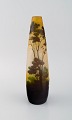 Antique Emile Gallé vase in yellow frosted and dark art glass carved in the form 
of a park landscape with trees and a bridge. Rare model. Early 20th century.
