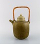 Frode Blichfeldt Bahnsen for Palshus. Teapot in glazed stoneware with wicker 
handle. Beautiful glaze in shades of green. 1960s.
