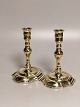 A pair of baroque brass candlesticks on an oval base. Stamped