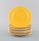 11 Royal Copenhagen / Aluminia Confetti plates in yellow glazed faience. 
Mid-20th century.
