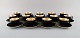 14 Royal Copenhagen / Aluminia Confetti coffee cups with saucers in black glazed 
faience with gold inside. Mid-20th century.
