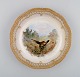 Early and rare Royal Copenhagen Fauna Danica plate in hand-painted porcelain 
with hunting motif and gold decoration. 19th century.
