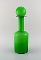 Otto Brauer for Holmegaard. Large rare vase / bottle in light green art glass 
with light green ball. 1960