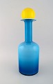 Otto Brauer for Holmegaard. Large vase / bottle in blue art glass with yellow 
ball. 1960s.

