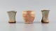 Danish studio ceramicist. Three unique vases in glazed stoneware. Beautiful 
glazes in peach and light earth shades. Late 20th century.
