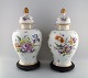 Two colossal German Dresden lidded porcelain bojans on wooden stands. 
Hand-painted flowers and gold decoration. 19th century.
