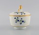 Antique German sugar bowl in hand-painted porcelain with flowers and gold edges. 
Lid knob modeled as a lion. 19th century.
