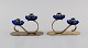 Gunnar Ander for Ystad Metall. Two candlesticks in brass and blue art glass 
shaped like flowers. 1950s.
