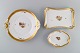 Three Royal Copenhagen Golden Basket dishes in porcelain with flowers and gold 
decoration. Early 20th century.
