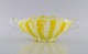 Murano bowl with handles in mouth-blown art glass. Wavy and checkered design in 
shades of yellow and white. 1960s.
