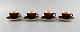 Four Royal Copenhagen / Aluminia Confetti mocha cups with saucers in glazed 
faience with interior gold. Mid-20th century.
