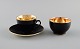 Royal Copenhagen / Aluminia Confetti mocha cup with saucer and sugar bowl in 
black glazed faience with interior gold. Mid-20th century.
