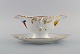Royal Copenhagen Saxon Flower sauce boat in hand-painted porcelain with flowers 
and gold decoration. Model number 493/1650. Early 20th century.

