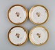 Four Royal Copenhagen Golden Basket plates in porcelain with flowers and gold 
decoration. Model number 595/9588. 1960s.
