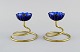 Gunnar Ander for Ystad Metall. Two candlesticks in brass and blue art glass 
shaped like flowers. 1950s.
