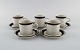 Anja Jaatinen-Winqvist for Arabia. Five Karelia coffee cups with saucers in 
glazed stoneware. 1970s.
