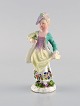 Meissen, Germany. Antique hand-painted porcelain figure. Lady with flowers. Late 
19th century.
