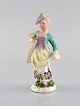 Meissen, Tyskland. Antik håndmalet porcelænsfigur. Dame med blomster. Sent 
1800-tallet.
