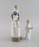 Lladro and Nao, Spain. Two porcelain figurines. Girl with lamb and angel boy. 
1970s / 80s.
