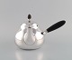 Georg Jensen art nouveau teapot in sterling silver with shaft and knob in ebony. 
Model number 80C. Designed in 1915.
