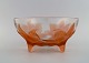 René Lalique (1860-1945), France. Rare "Lys" bowl on feet in clear and orange 
mouth blown art glass with four lilies. 1920s.
