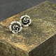 A pair of ear studs with roses