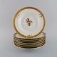 Eight Royal Copenhagen Golden Basket deep plates in hand-painted porcelain with 
flowers and gold decoration. 1960s. Model number 595/9587.
