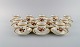 12 Royal Copenhagen Brown Rose mocha / coffee cups with saucers in hand-painted 
porcelain with flowers and gold edge. Dated 1968.
