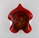 Large leaf-shaped Murano bowl in mouth-blown art glass with wavy edges. Red 
shades. Italian design, 1960s.
